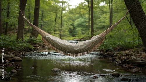 Relaxing in a yellow hammock by a serene forest stream on a bright sunny day