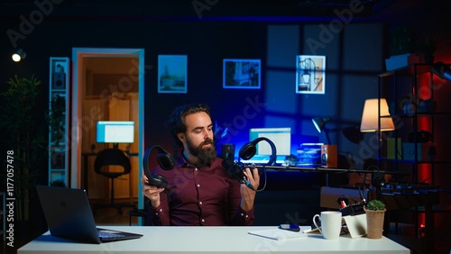 Tech expert testing headphones, review them for online streaming platforms. Professional audiophile hosts internet show, using sound mixer to check audio device sound sensitivity, camera B