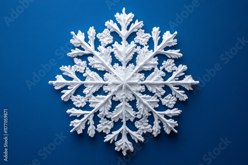 Decorative white snowflake design against a vibrant blue background