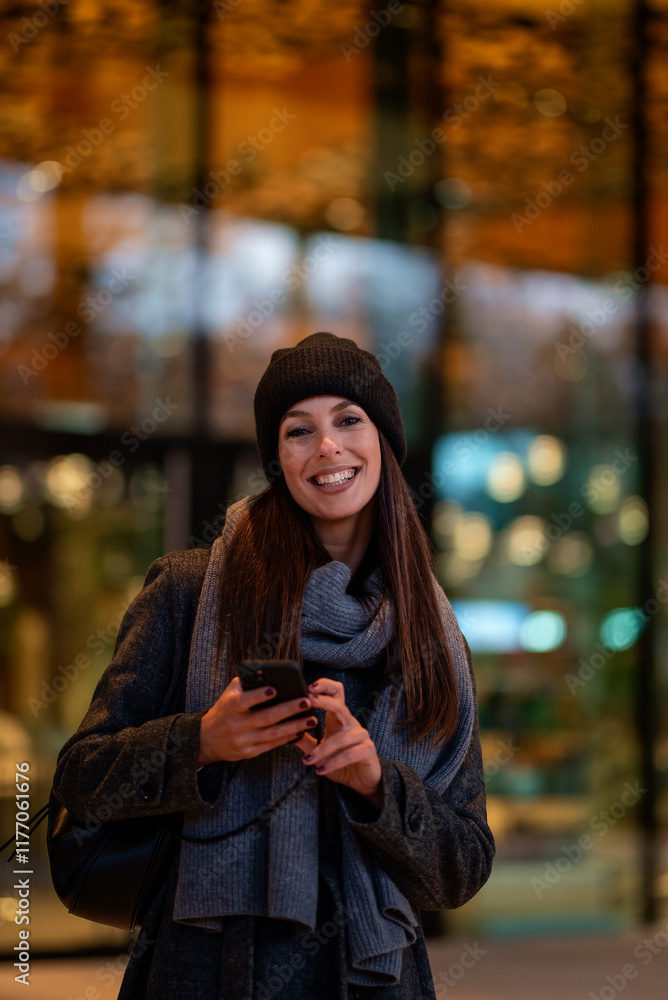 Happy mid aged woman standin outdoor and using her smartphone Happy mid aged woman standin outdoor and using her smartphone