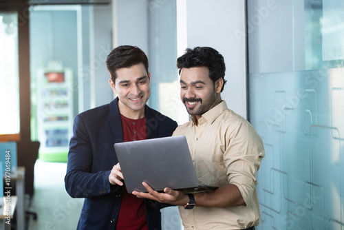 Business Partners Talking While Viewing The Laptop Screen