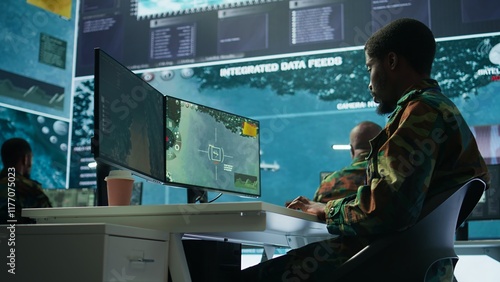 Military personnel in a control center working on data processing, integrating real time surveillance and security protocols essential for national defense and strategic operations. Camera B. photo