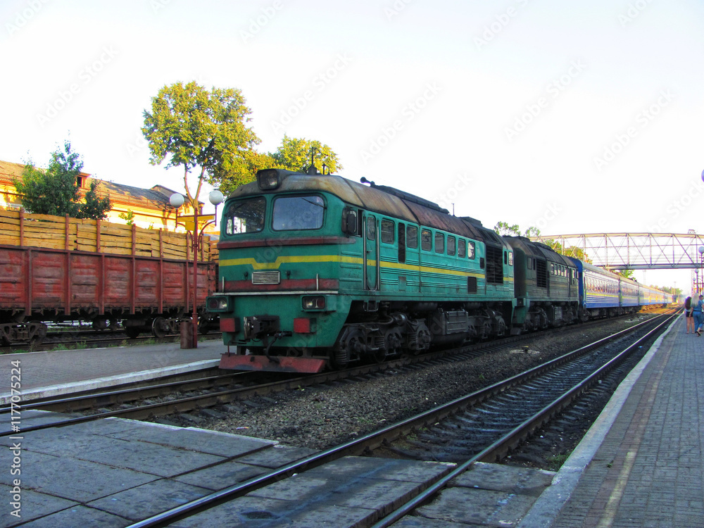 Naklejka premium A vintage locomotive at a rural train station