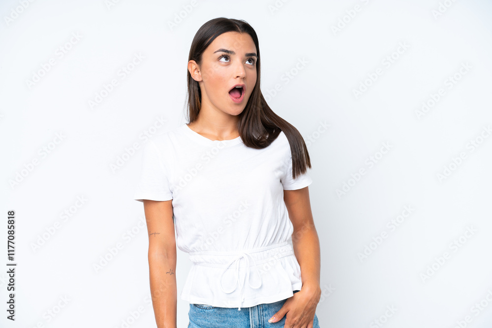 Young caucasian woman isolated on white background looking up and with surprised expression