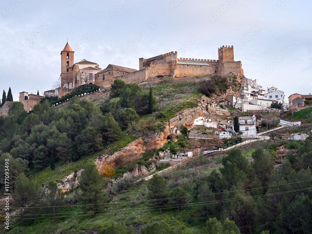 Fototapeta premium Iznajar village. Mountain village surrounded by the Iznajar Reservoir. Parish of Santiago Apostol. Iznajar Castle