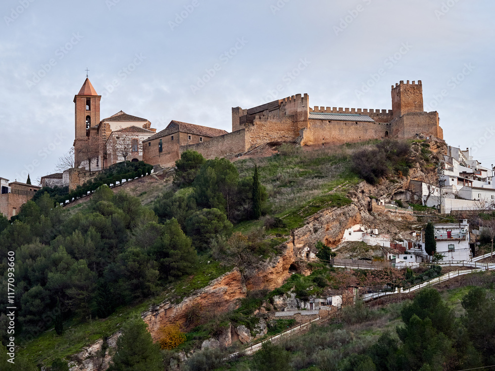 Fototapeta premium Iznajar village. Mountain village surrounded by the Iznajar Reservoir. Parish of Santiago Apostol. Iznajar Castle