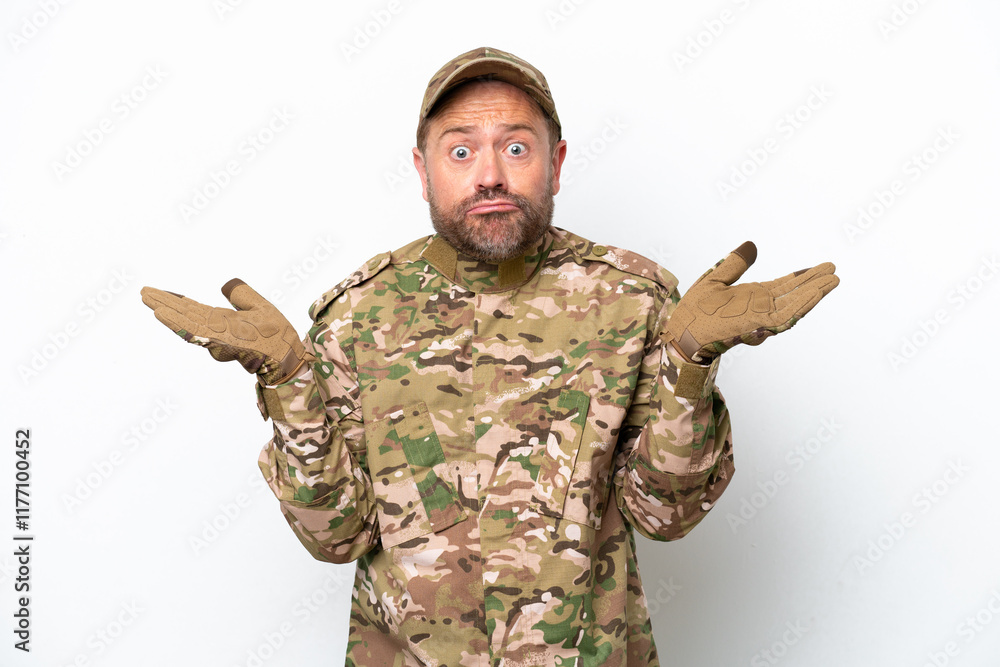 Military man isolated on white background having doubts while raising hands Military man isolated on white background having doubts while raising hands