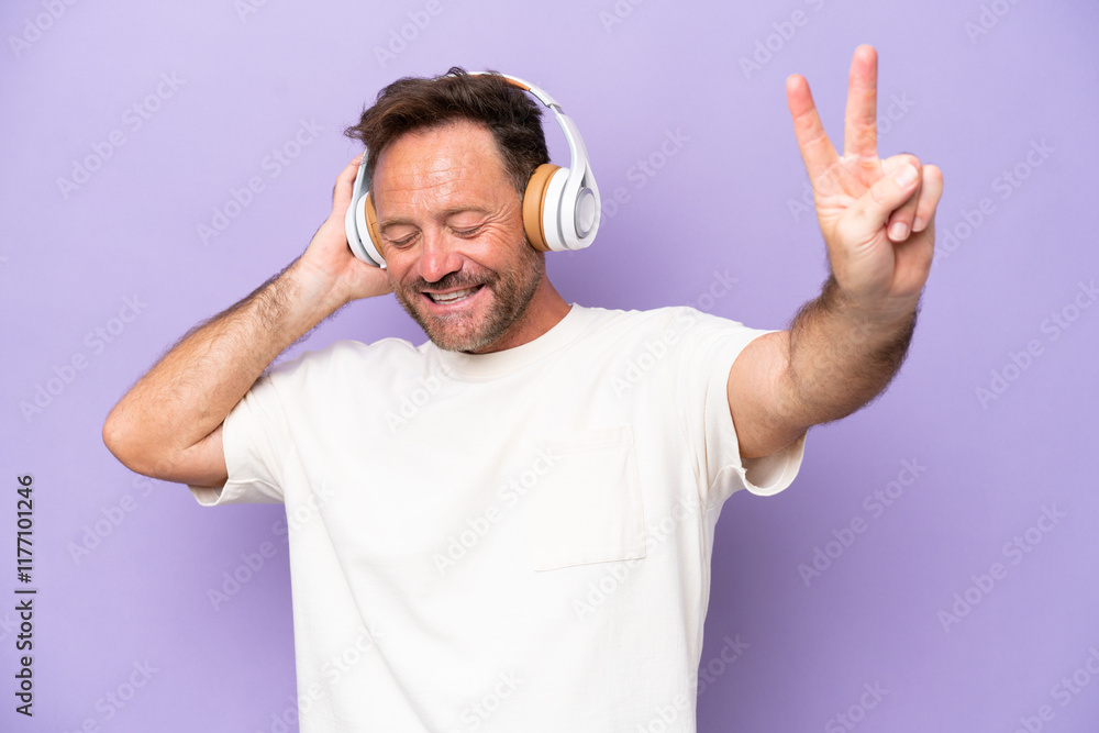 Middle age caucasian man isolated on purple background listening music and singing Middle age caucasian man isolated on purple background listening music and singing