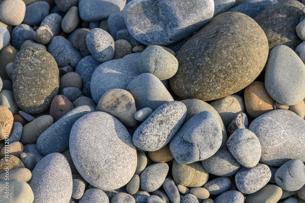 Textures of nature captured through a collection of smooth pebbles along a serene riverbank Textures of nature captured through a collection of smooth pebbles along a serene riverbank