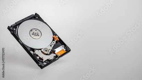 a computer's hard disk hdd data storage drive without shield isolated  in white background show magnetic disc and electronic part inside
