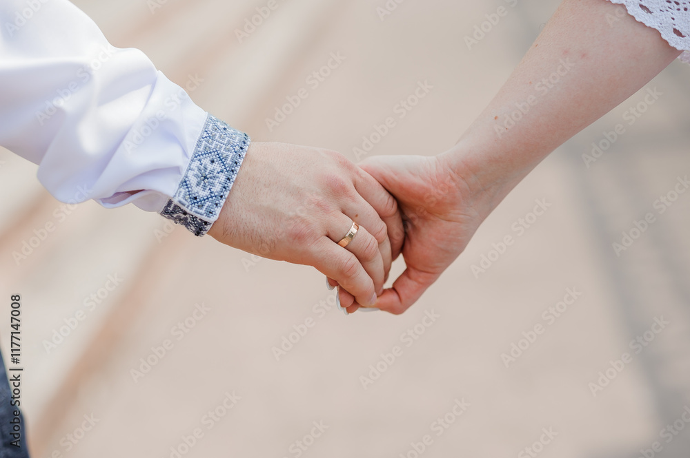 Romantic Moment: A Close-Up of Intertwined Hands with Wedding Ring Romantic Moment: A Close-Up of Intertwined Hands with Wedding Ring