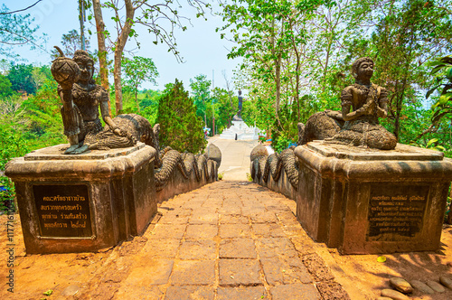 The scenic sculptures at the top of the staircases of Phrathat Pukhaw temple complex, Ban Sop Ruak, Thailand photo