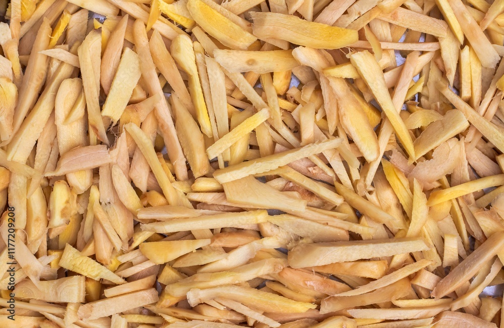 Raw Ginger Slices Heap Background with Copy Space in Horizontal Orientation Raw Ginger Slices Heap Background with Copy Space in Horizontal Orientation