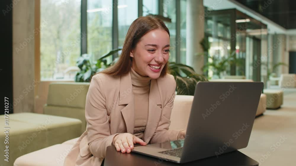 Happy businesswoman girl using laptop computer typing browsing, celebrating success victory, winning lottery casino jackpot achievement, play game, good positive news, triumph in modern office lobby Happy businesswoman girl using laptop computer typing browsing, celebrating success victory, winning lottery casino jackpot achievement, play game, good positive news, triumph in modern office lobby
