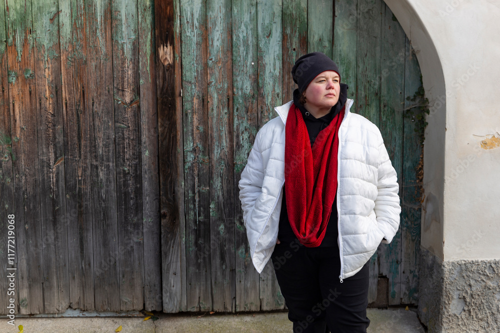 A plus-size woman strolling through the streets of a small European town.