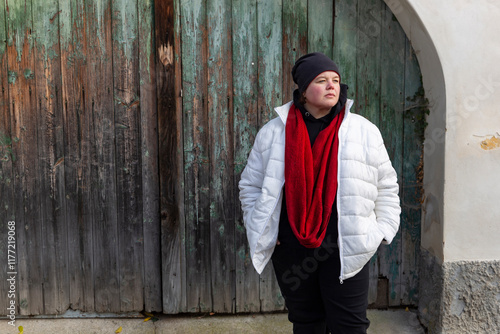 A plus-size woman strolling through the streets of a small European town.