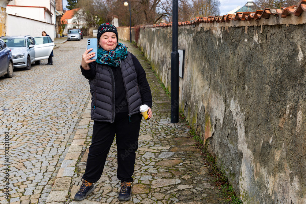A woman walking through the city on an autumn day.