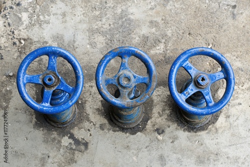 Wallpaper Mural Three Blue Industrial Valves on a Dirty Concrete Surface for Mechanical Applications Torontodigital.ca