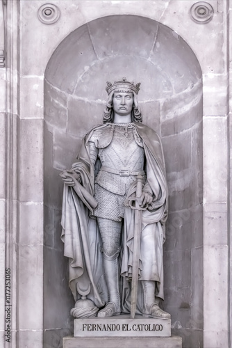 Marble statue of King Fernando El Catolico inside the Royal Palace of Madrid. The statue showcases the detailed armor and royal attire. Madrid, Spain - November 30, 2021 photo