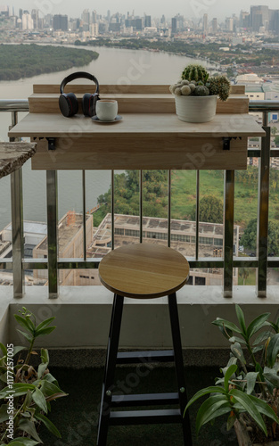 Obraz na płótnie Decorated balcony with Adjustable balcony bar table and wood chair. Relaxation area on Condominium balcony overlooking river view, Cozy space with Ear headphones,Tea cup and Cactus pot on Folding deck w salonie