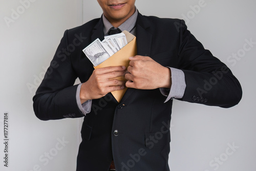 Canvas Print Businessman Hiding Money in Envelope Symbolizing Corruption and Financial Miscon
