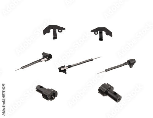 Various firearm components, including firing pins and springs, arranged on a white background photo