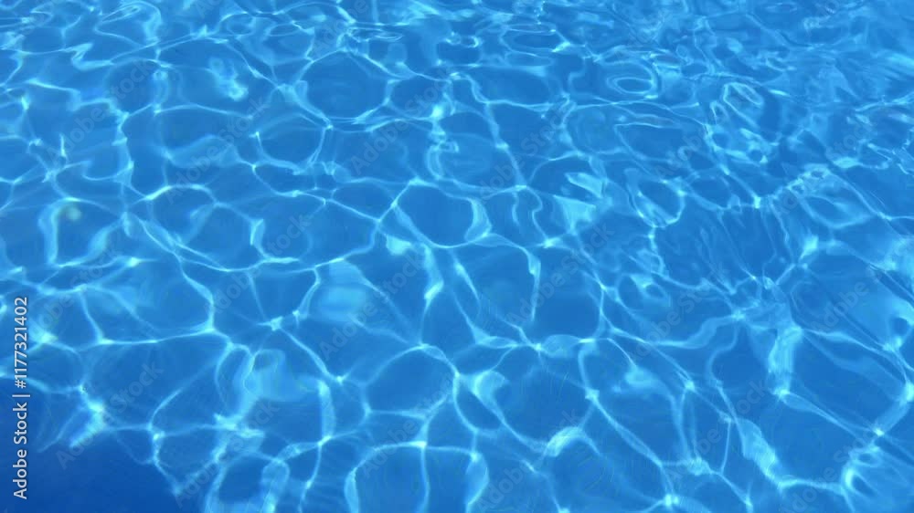 Tranquil, crystal-clear pool with ripples reflecting sunlight on the blue water, creating mesmerizing patterns. The fluidity and light reflections highlight the serene, refreshing ambiance of a summer Tranquil, crystal-clear pool with ripples reflecting sunlight on the blue water, creating mesmerizing patterns. The fluidity and light reflections highlight the serene, refreshing ambiance of a summer