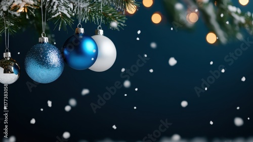 Sparkling blue and silver Christmas ornaments hang delicately, adding a festive touch to holiday decorations.