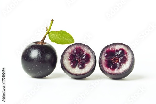 Three whole and halved jaboticaba fruits on a white background