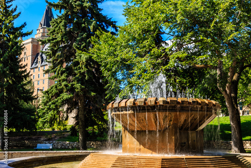 A large fountain with water shooting out of it in a park photo