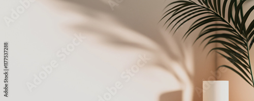 Empty white podium with palm leaf casting shadows on beige background