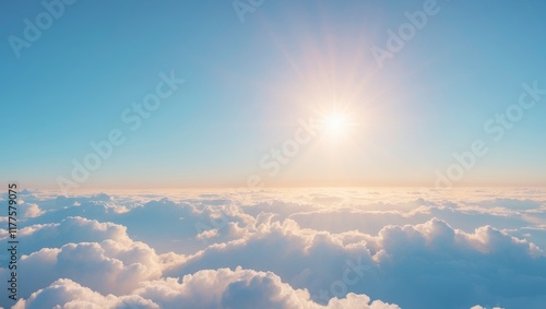 Bright sun shining over fluffy white clouds in a clear blue sky