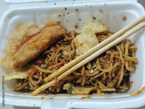 Mie Gacoan, Popular Spicy Indonesian Fried Noodle with Fried Dumpling. photo