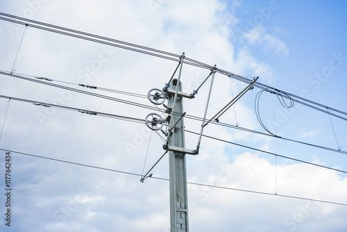 Wallpaper Mural Pole support for electric wires for urban electric transport. Image of electric pole with wiring for electric vehicles against bright blue sky background Torontodigital.ca