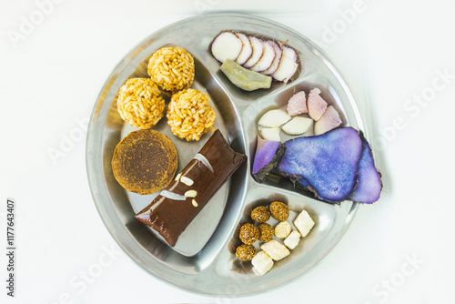 A Plate of jaggery, sesame balls, yam, sweet potato for Maghe Sankranti Festival or Pre Workout Meal photo