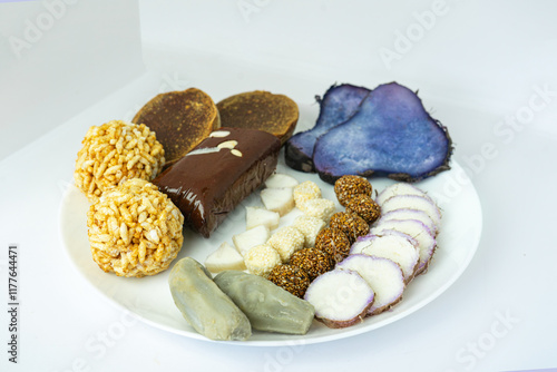 A Plate of jaggery, sesame balls, yam, sweet potato for Maghe Sankranti Festival or Pre Workout Meal photo