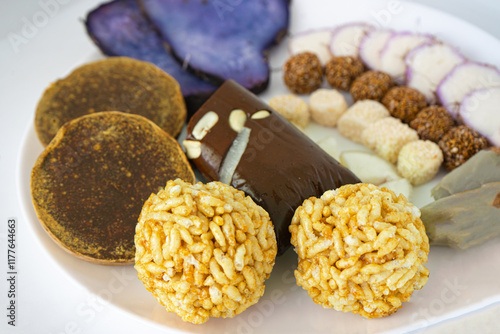 A Plate of jaggery, sesame balls, yam, sweet potato for Maghe Sankranti Festival or Pre Workout Meal photo