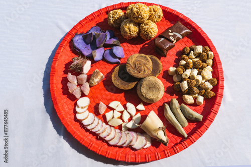 A Plate of jaggery, sesame balls, yam, sweet potato for Maghe Sankranti Festival or Pre Workout Meal photo