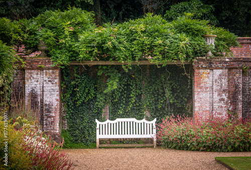 Photos White garden bench in semi formal garden setting