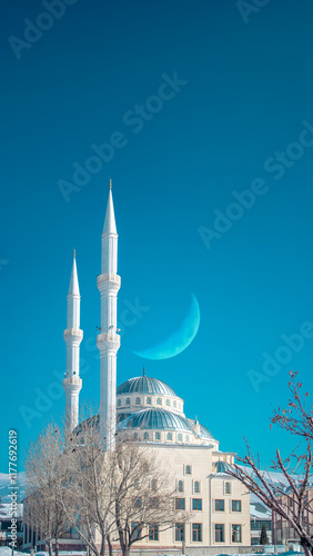 Ramadan or Islamic background photo: Alkazan Mosque under crescent moon