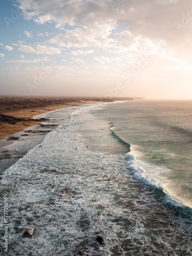 Vertical shot capturing a dramatic coastal scene with towering ocean waves