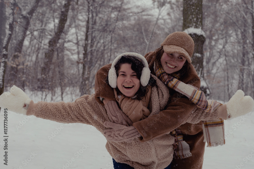 Obraz premium two women are sculpting snowmen in a winter forest