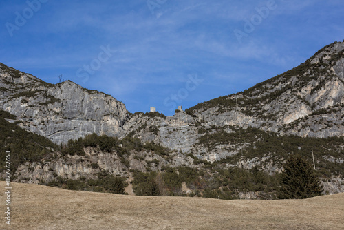 Rocky cliffs with ancient ruins under blue sky photo