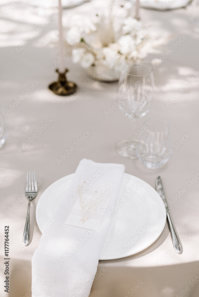 Elegant wedding table setting with floral decorations and candles Elegant wedding table setting with floral decorations and candles