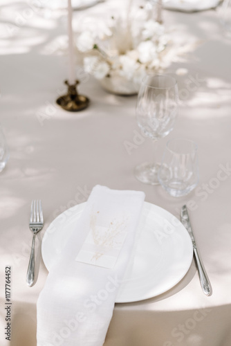 Elegant wedding table setting with floral decorations and candles photo