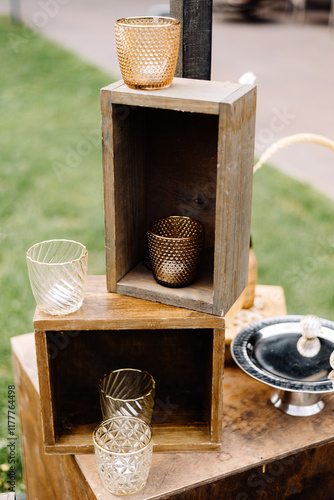 Elegant wedding decoration with glassware and wooden boxes photo