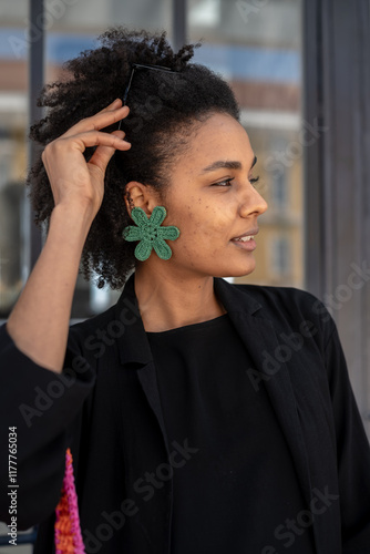 African woman with flower earring looking away photo