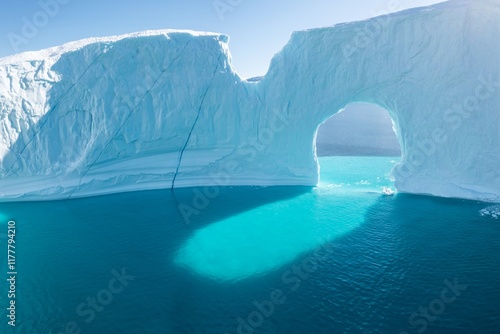 Big icebergs in Atlantic ocean, Ilulissat icefjord, western Greenland. Blue sea and the blue sky at sunrise.
Melting icebergs by the coast of Greenland, on a beautiful summer day. Global warming photo