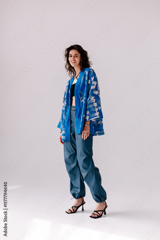 Stylish model wearing a blue patterned jacket and pants Stylish model wearing a blue patterned jacket and pants