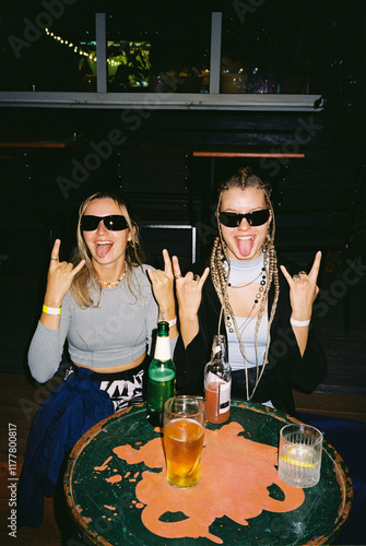 Two friends having fun at a lively bar photo